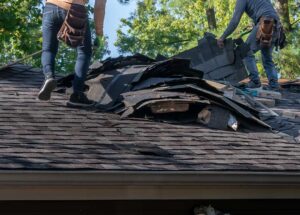 Roof eaves with soffit vents and gutters directing rainwater away from a two-story home.